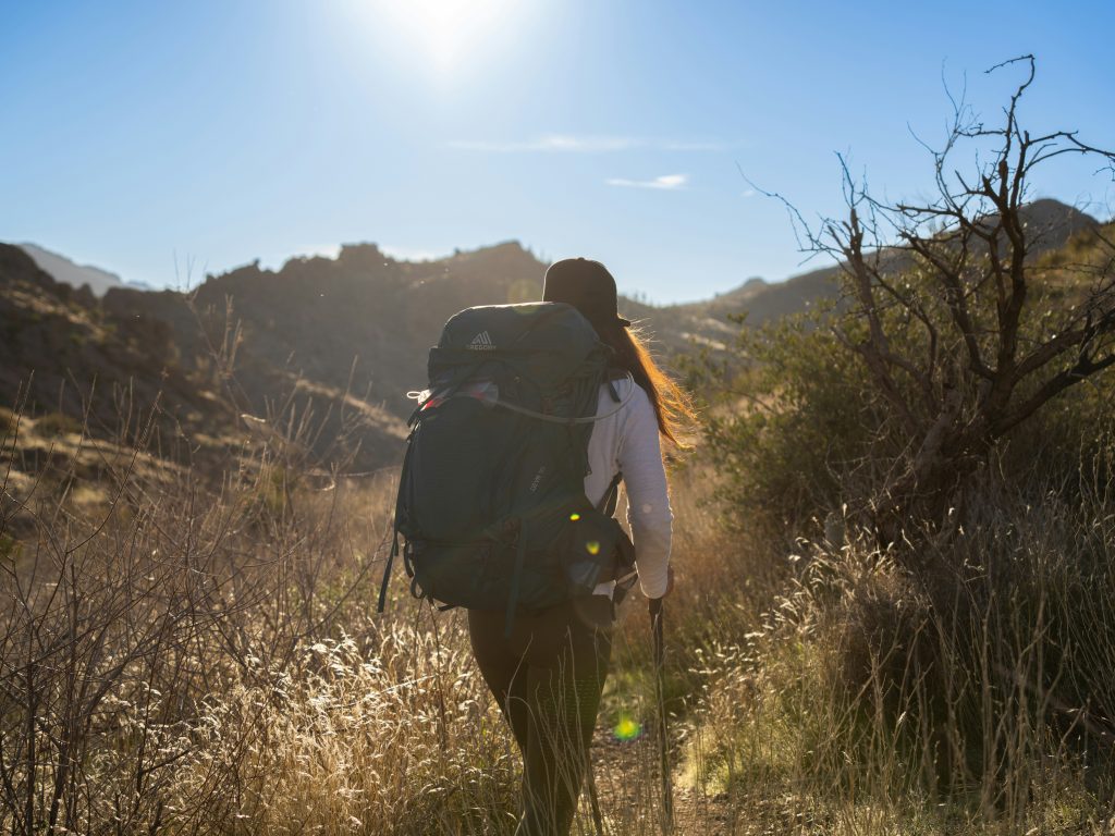 Beginner rucking with a loaded backpack on a trail