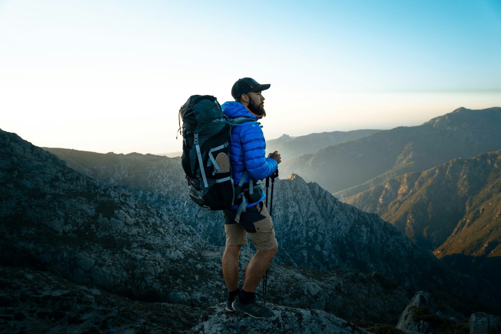 Person walking with a weighted backpack outdoors